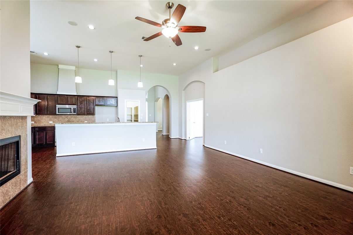 Empty room, Fireplace, Interior, Kitchen, Pendant Lights, Recessed Lighting, Wood Texture Flooring