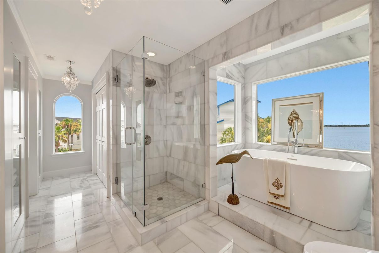 Bathroom, Chandelier, Free Standing Baths, Glass Shower, Interior, Marble, Marble Walls, Recessed Lighting, Water