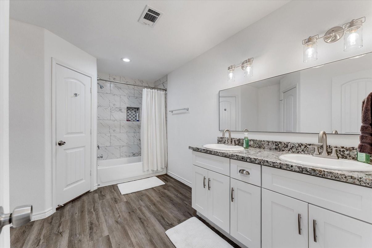 Bathroom, Dual Sink Vanities, Interior, Marble Walls, Recessed Lighting, Wood Texture Flooring