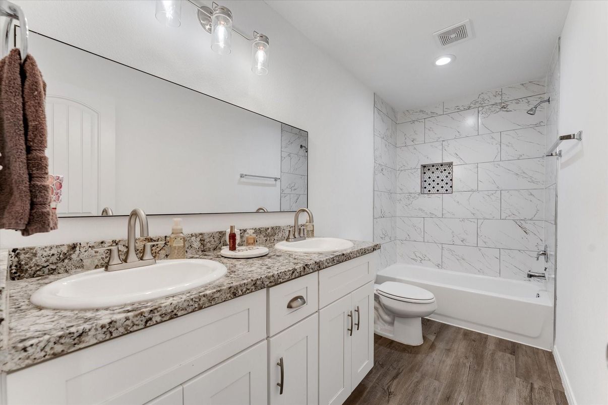 Bathroom, Dual Sink Vanities, Interior, Marble Walls, Recessed Lighting, Wood Texture Flooring