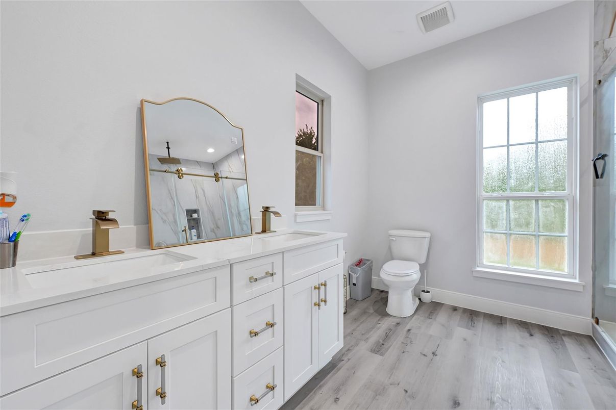 Bathroom, Dual Sink Vanities, Interior, Marble Walls, Recessed Lighting, Wood Texture Flooring