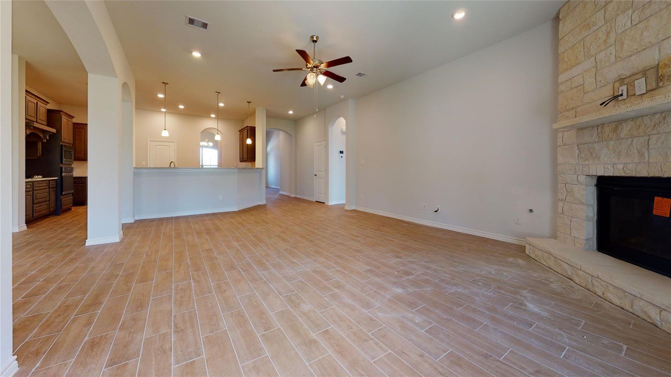 Empty room, Fireplace, Interior, Kitchen, Pendant Lights, Recessed Lighting, Stone Walls, Wood Texture Flooring
