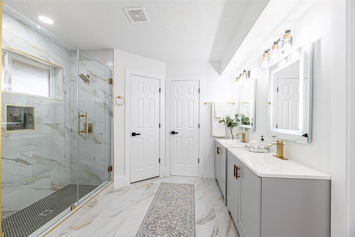 Bathroom, Dual Sink Vanities, Glass Shower, Interior, Marble, Marble Walls, Recessed Lighting