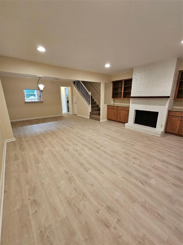 Empty room, Fireplace, Interior, Recessed Lighting, Stone Walls, Wood Texture Flooring
