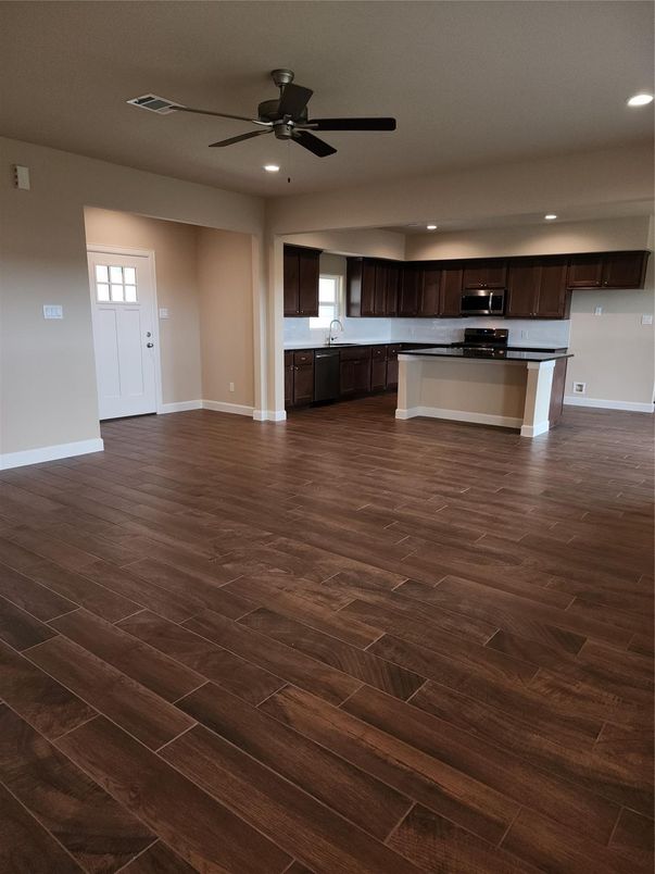 Empty room, Interior, Kitchen, Recessed Lighting, Stainless Steel Appliances, Wood Texture Flooring