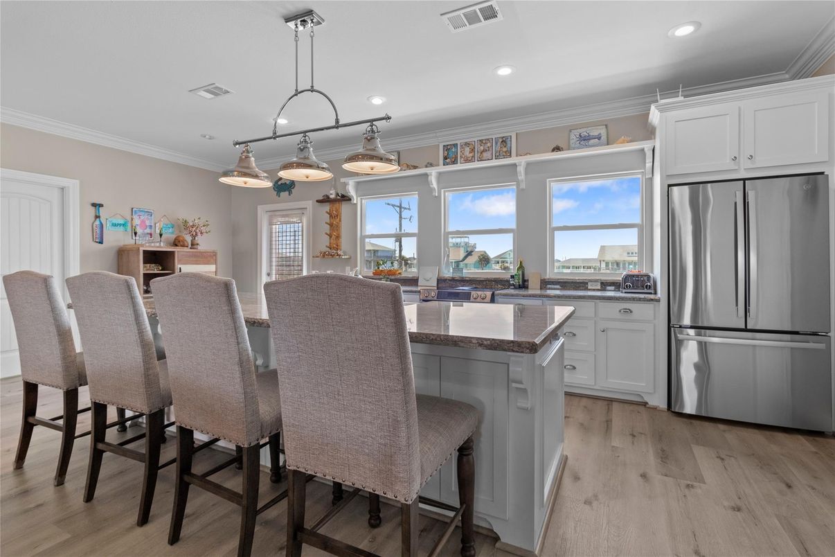 Dining room, Interior, Kitchen, Pendant Lights, Recessed Lighting, Stainless Steel Appliances, Wood Texture Flooring