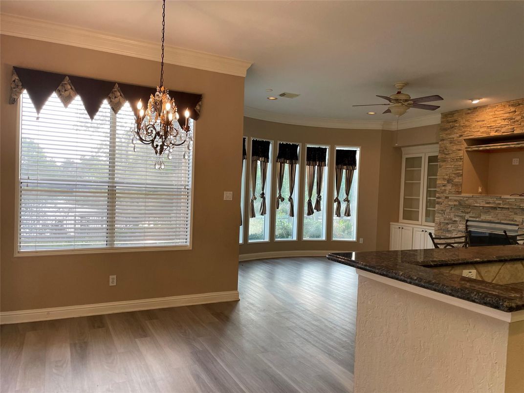 Chandelier, Empty room, Fireplace, Interior, Recessed Lighting, Stone Walls, Wood Texture Flooring