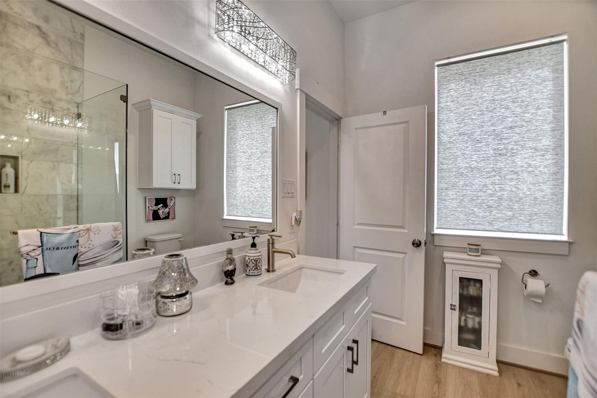 Bathroom, Dual Sink Vanities, Glass Shower, Interior, Marble Walls, Wood Texture Flooring