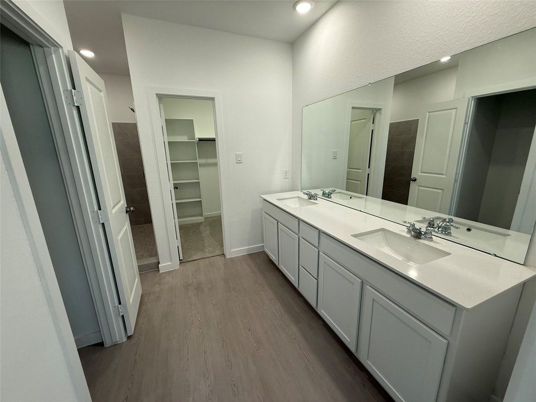 Bathroom, Dual Sink Vanities, Interior, Recessed Lighting, Walk-in Closets, Wood Texture Flooring