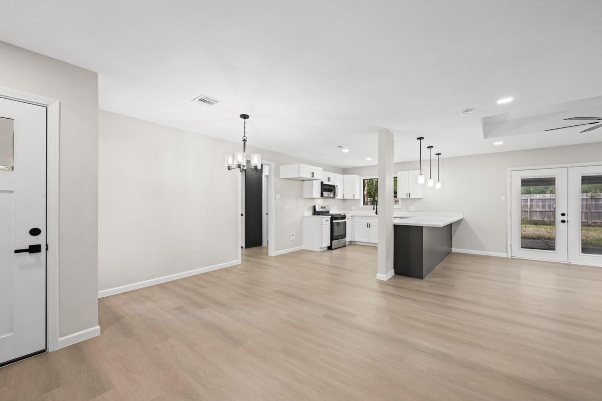 Chandelier, Empty room, Interior, Kitchen, Pendant Lights, Recessed Lighting, Stainless Steel Appliances, Wood Texture Flooring