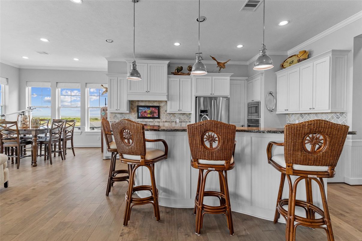 Dining room, Interior, Kitchen, Pendant Lights, Recessed Lighting, Stainless Steel Appliances, Wood Texture Flooring