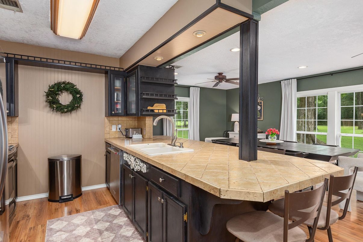 Dining room, Fireplace, Interior, Kitchen, Recessed Lighting, Tile Countertops, Wood Texture Flooring