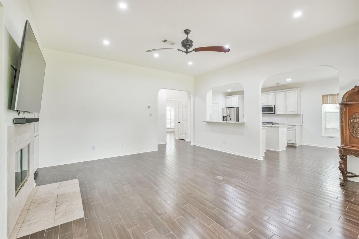 Empty room, Fireplace, Interior, Kitchen, Recessed Lighting, Wood Texture Flooring