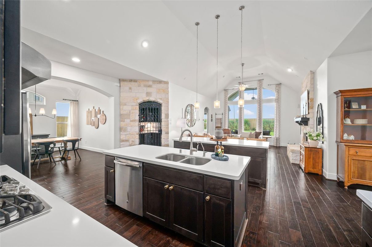 Dining room, Fireplace, Interior, Kitchen, Pendant Lights, Recessed Lighting, Stainless Steel Appliances, Stone Walls, Wood Texture Flooring