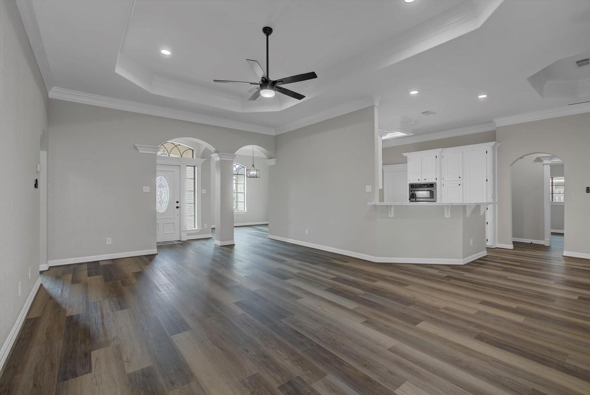Empty room, Interior, Kitchen, Recessed Lighting, Stainless Steel Appliances, Wood Texture Flooring