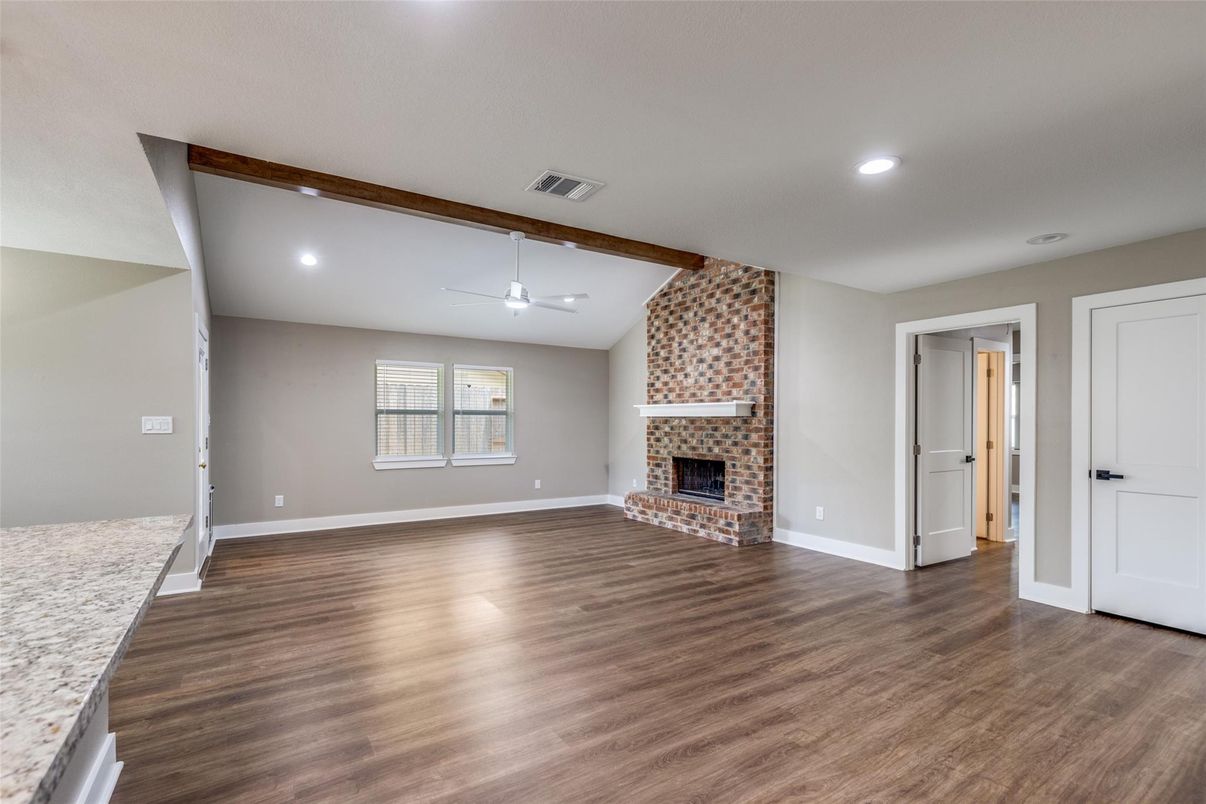 Empty room, Fireplace, Interior, Recessed Lighting, Stone Walls, Wooden Beams, Wood Texture Flooring