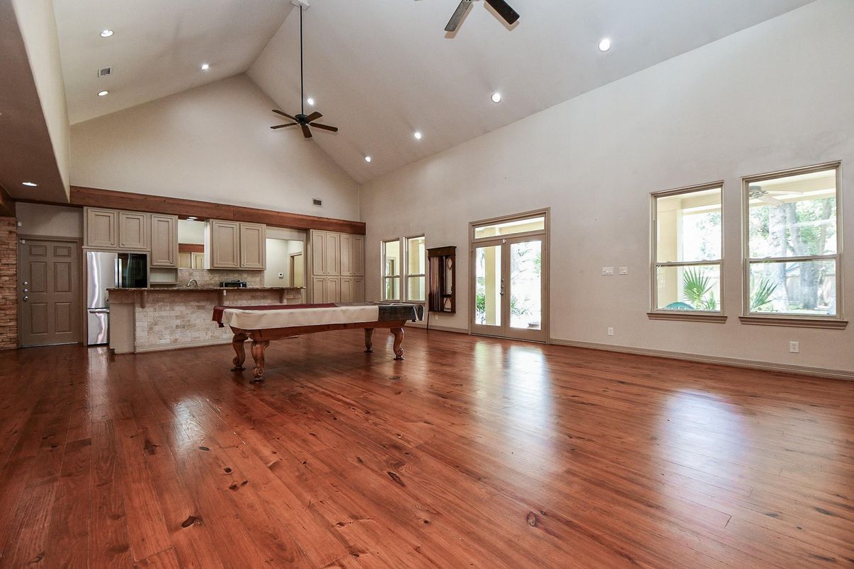 Billiard Table, Empty room, Game Room, Interior, Kitchen, Recessed Lighting, Stainless Steel Appliances, Wood Texture Flooring