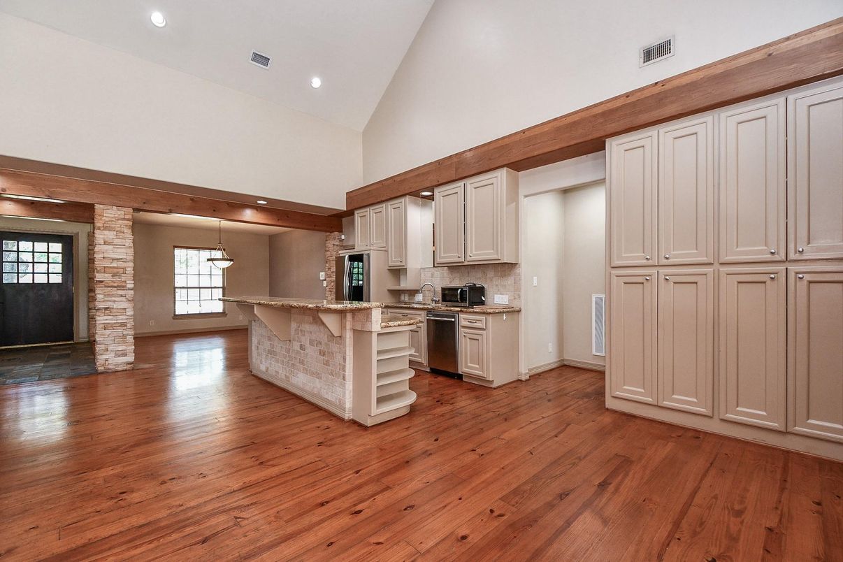 Empty room, Interior, Kitchen, Pendant Lights, Recessed Lighting, Stainless Steel Appliances, Stone Walls, Wood Texture Flooring