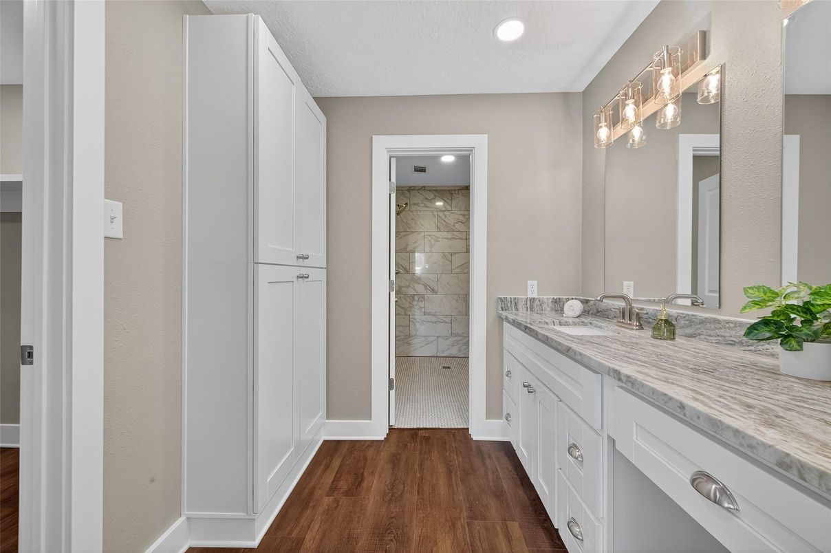Bathroom, Dual Sink Vanities, Interior, Marble Walls, Recessed Lighting, Wood Texture Flooring