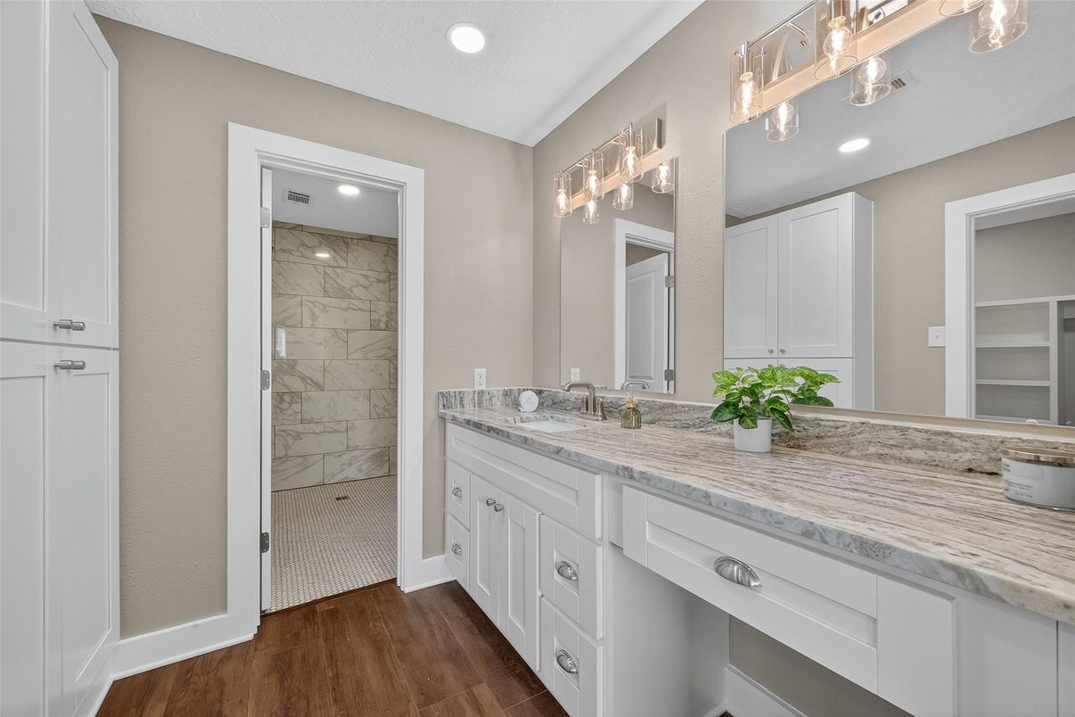 Bathroom, Dual Sink Vanities, Interior, Marble Walls, Recessed Lighting, Wood Texture Flooring