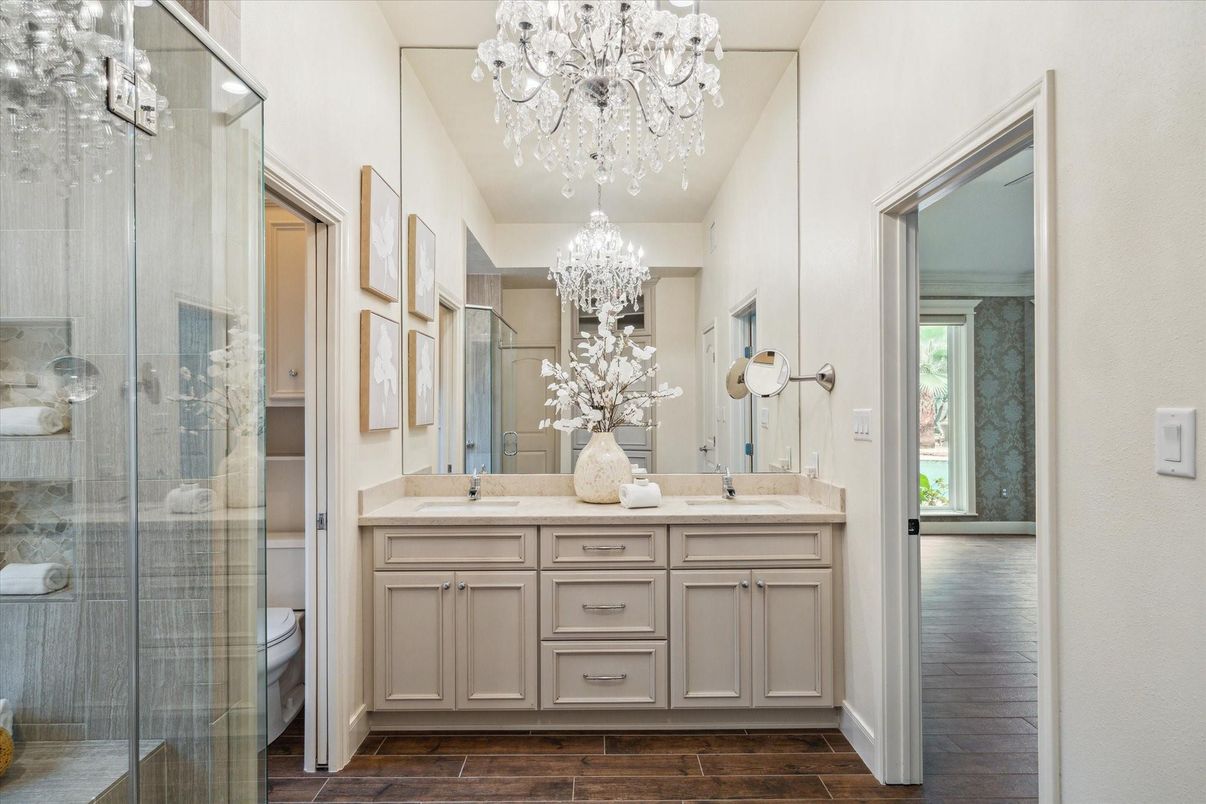 Bathroom, Chandelier, Dual Sink Vanities, Glass Shower, Interior, Wood Texture Flooring