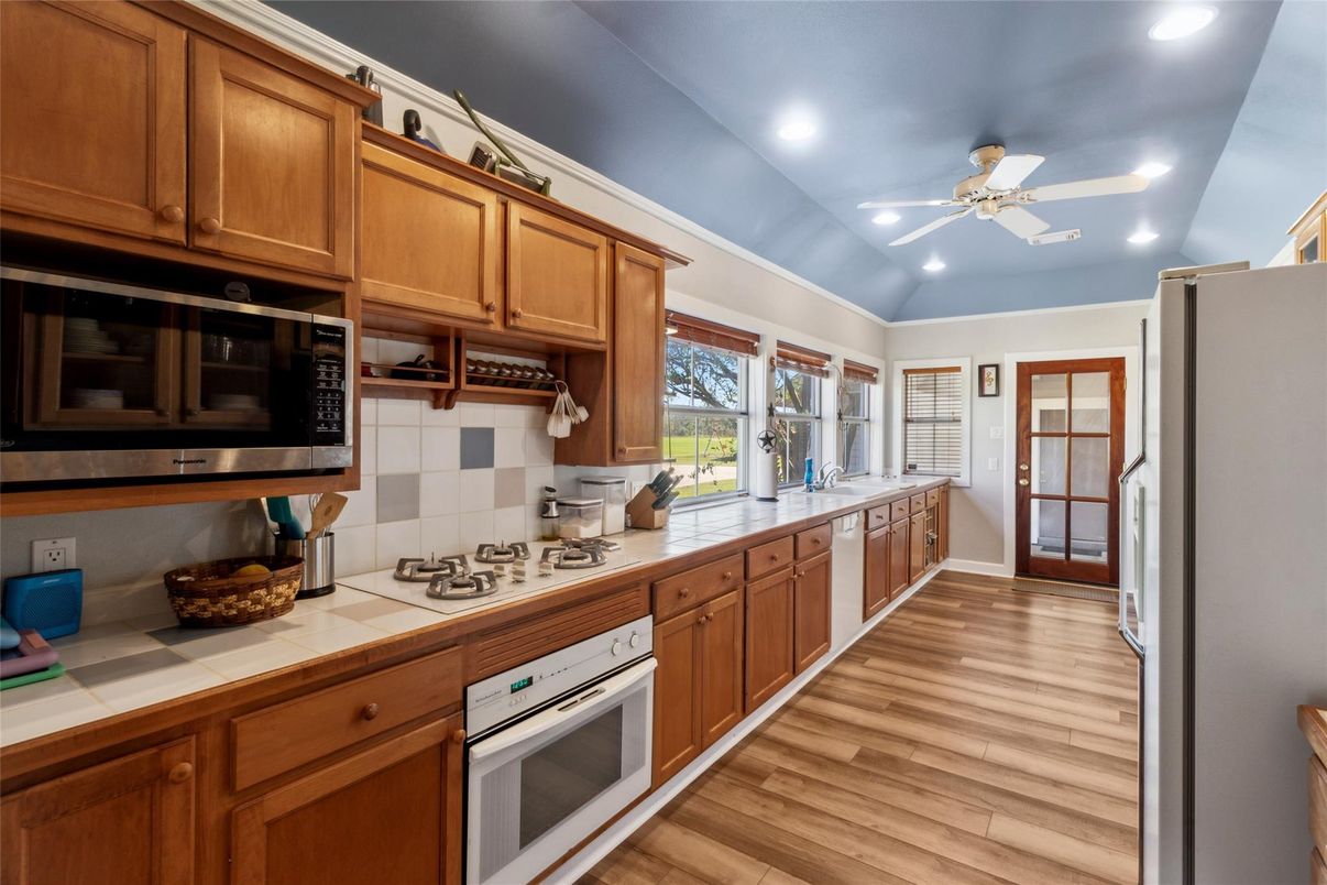Interior, Kitchen, Recessed Lighting, Tile Countertops, Wood Texture Flooring