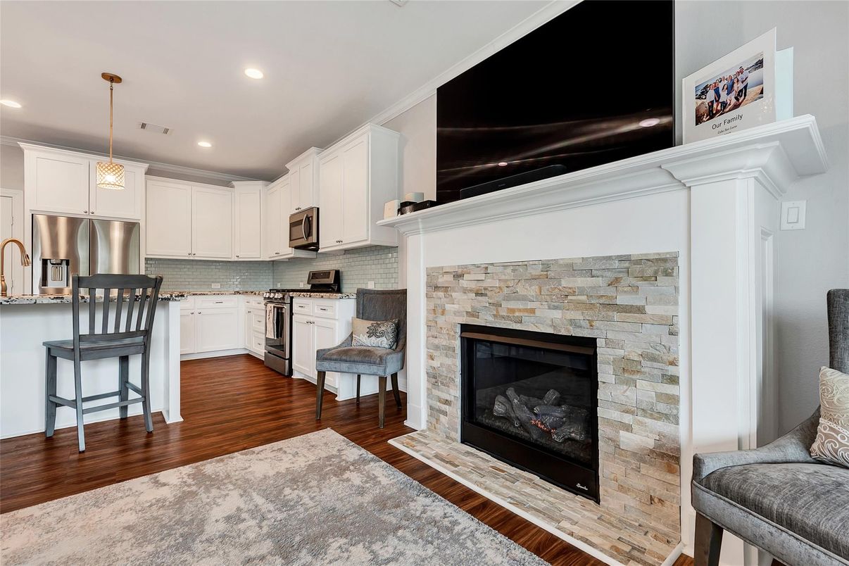 Fireplace, Interior, Kitchen, Pendant Lights, Recessed Lighting, Stainless Steel Appliances, Stone Walls, Wood Texture Flooring