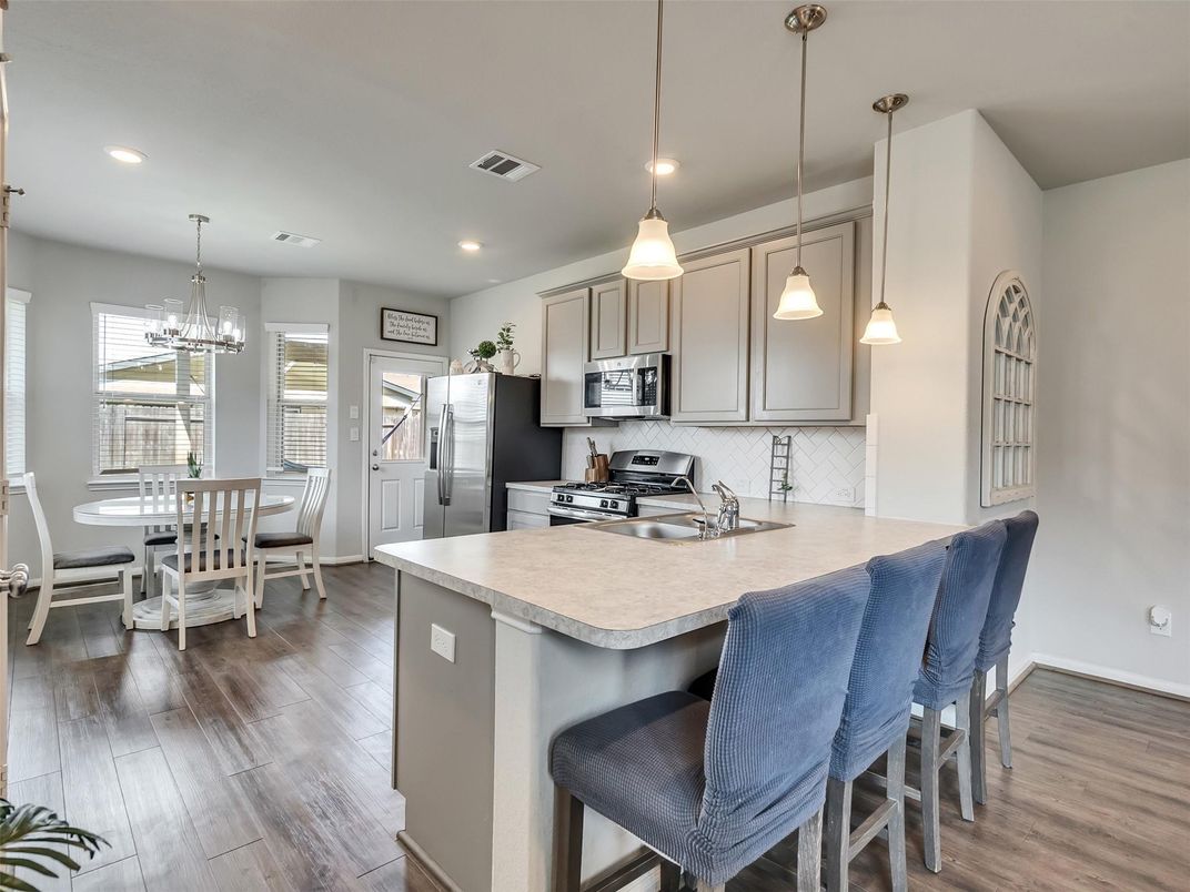 Chandelier, Dining room, Interior, Kitchen, Pendant Lights, Recessed Lighting, Stainless Steel Appliances, Wood Texture Flooring