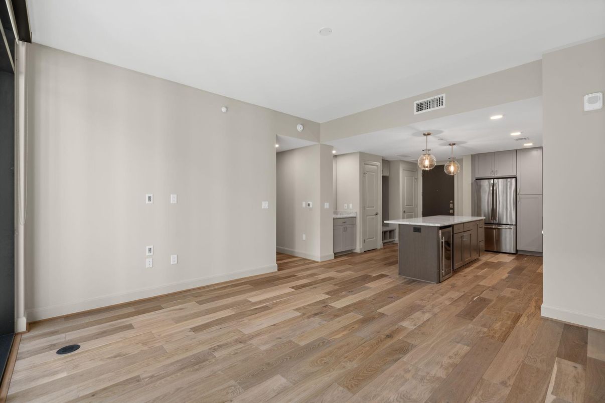 Empty room, Interior, Kitchen, Pendant Lights, Recessed Lighting, Stainless Steel Appliances, Wood Texture Flooring