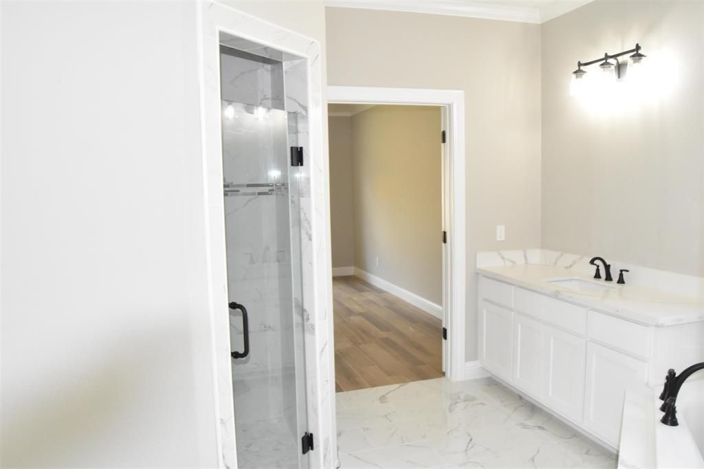 Bathroom, Dual Sink Vanities, Glass Shower, Interior, Marble, Marble Walls, Wood Texture Flooring