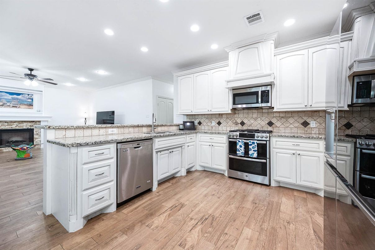 Fireplace, Interior, Kitchen, Recessed Lighting, Stainless Steel Appliances, Wood Texture Flooring