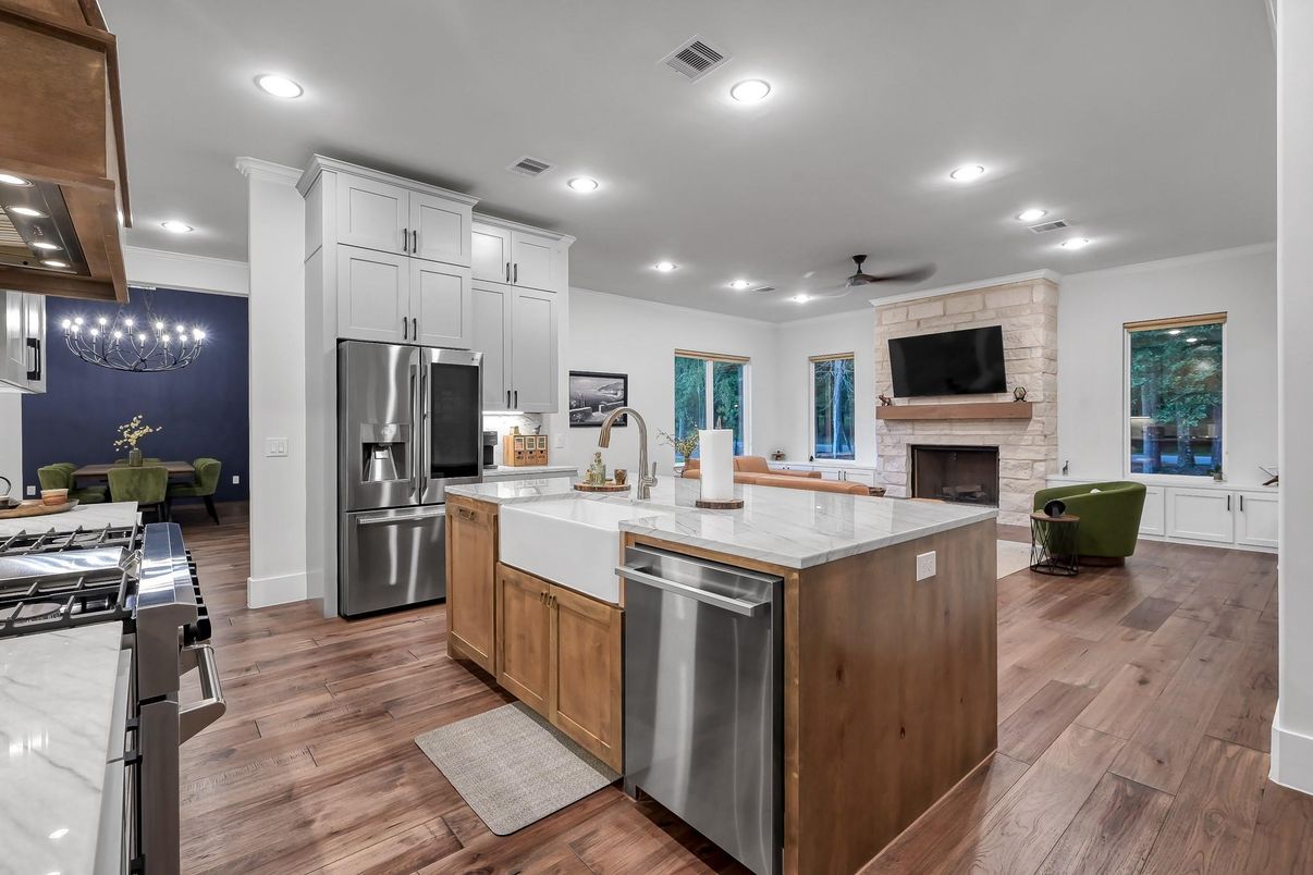 Chandelier, Dining room, Fireplace, Interior, Kitchen, Recessed Lighting, Stainless Steel Appliances, Stone Walls, Wood Texture Flooring