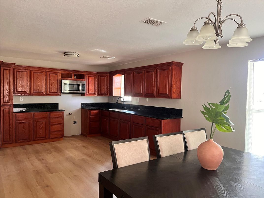 Chandelier, Dining room, Interior, Kitchen, Stainless Steel Appliances, Wood Texture Flooring