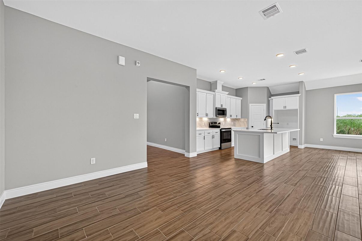 Empty room, Interior, Kitchen, Recessed Lighting, Stainless Steel Appliances, Wood Texture Flooring