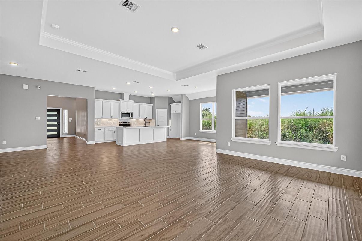 Empty room, Interior, Kitchen, Recessed Lighting, Stainless Steel Appliances, Wood Texture Flooring