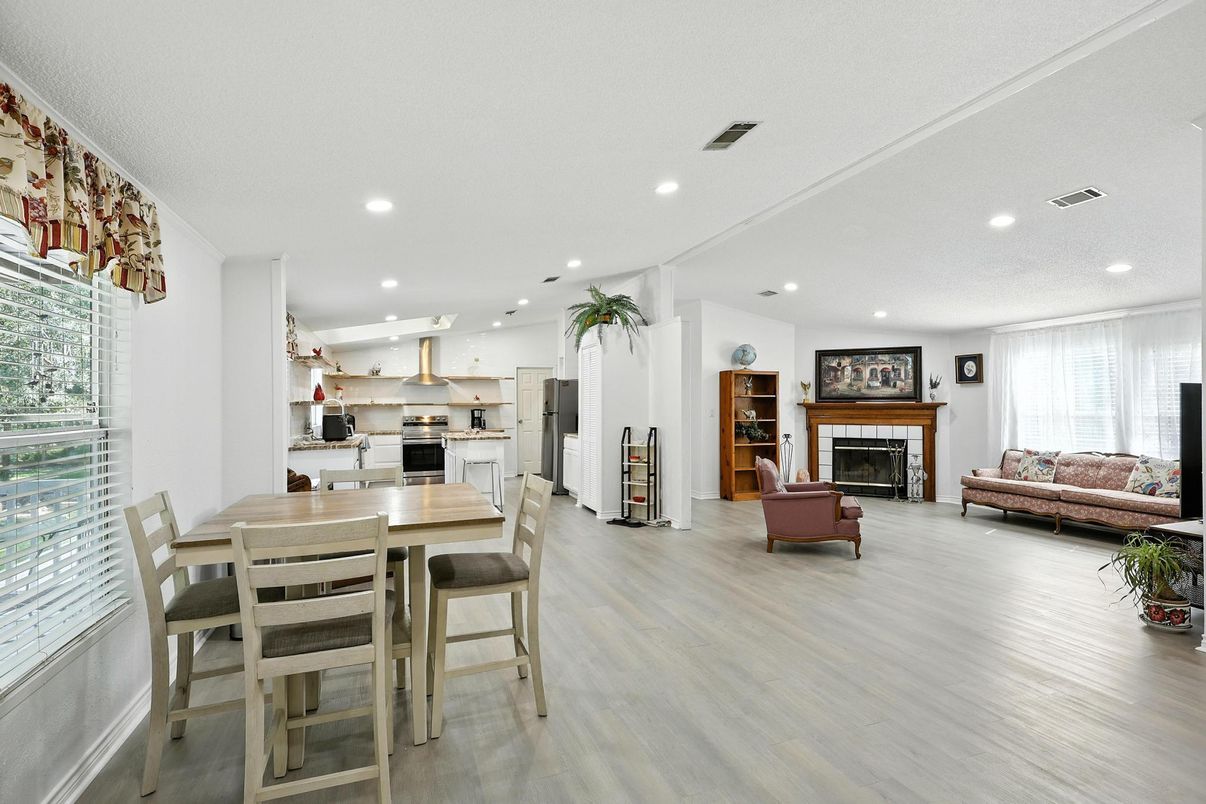 Dining room, Fireplace, Interior, Kitchen, Living room, Recessed Lighting, Stainless Steel Appliances, Wood Texture Flooring