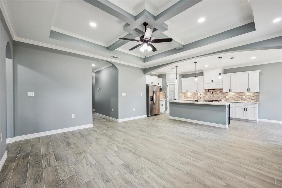 Empty room, Interior, Kitchen, Pendant Lights, Recessed Lighting, Stainless Steel Appliances, Wood Texture Flooring