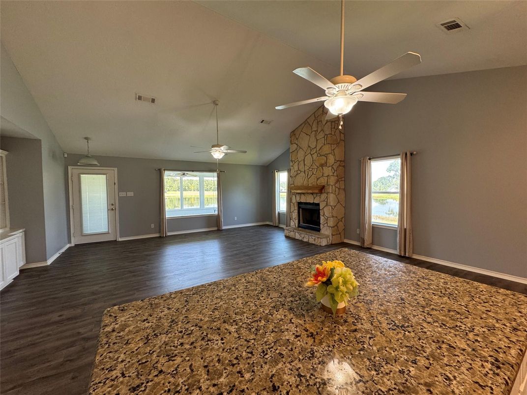 Empty room, Fireplace, Interior, Recessed Lighting, Stone Walls, Wood Texture Flooring