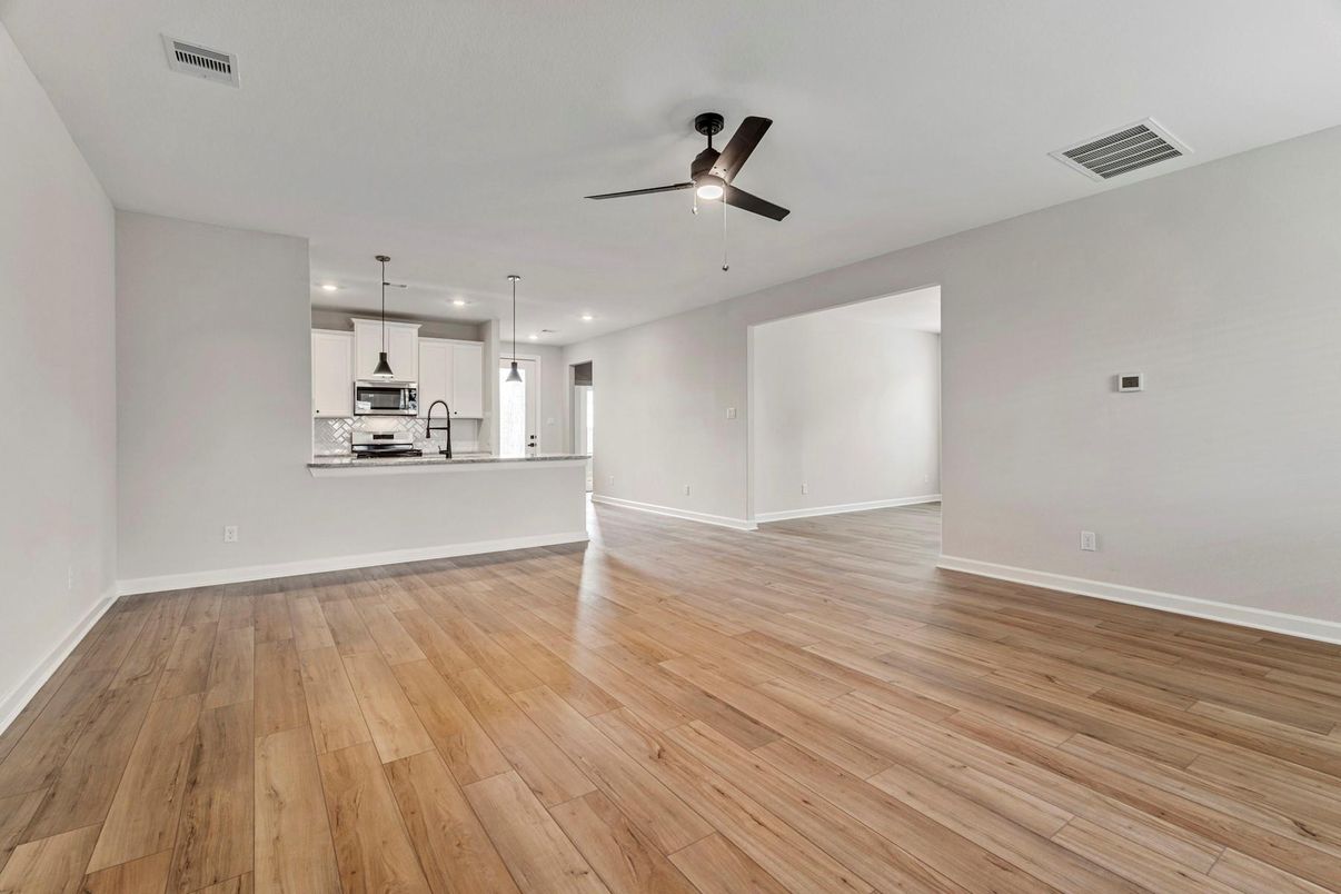 Empty room, Interior, Kitchen, Pendant Lights, Recessed Lighting, Stainless Steel Appliances, Wood Texture Flooring