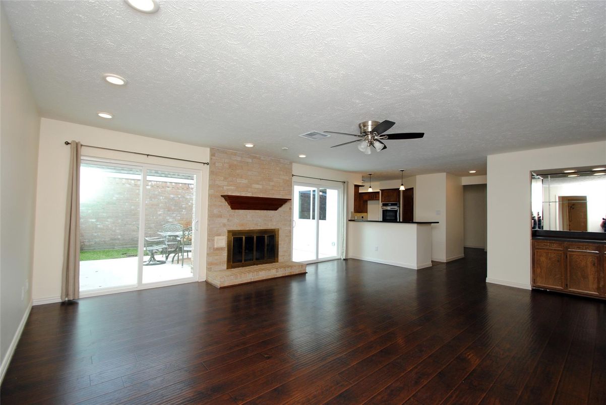 Empty room, Fireplace, Interior, Kitchen, Recessed Lighting, Wood Texture Flooring