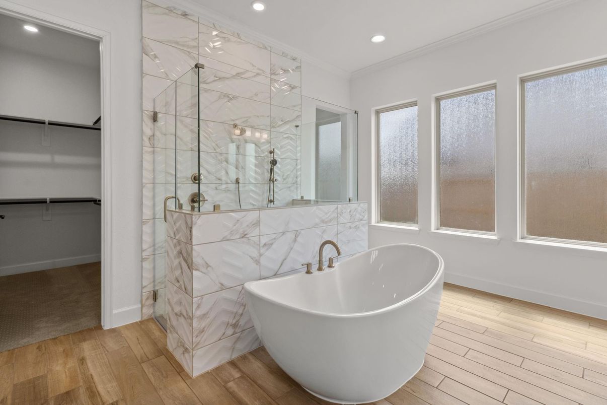 Bathroom, Free Standing Baths, Glass Shower, Interior, Marble Walls, Recessed Lighting, Walk-in Closets, Wood Texture Flooring