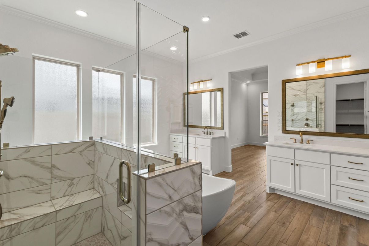 Bathroom, Dual Sink Vanities, Free Standing Baths, Glass Shower, Interior, Marble Walls, Recessed Lighting, Wood Texture Flooring