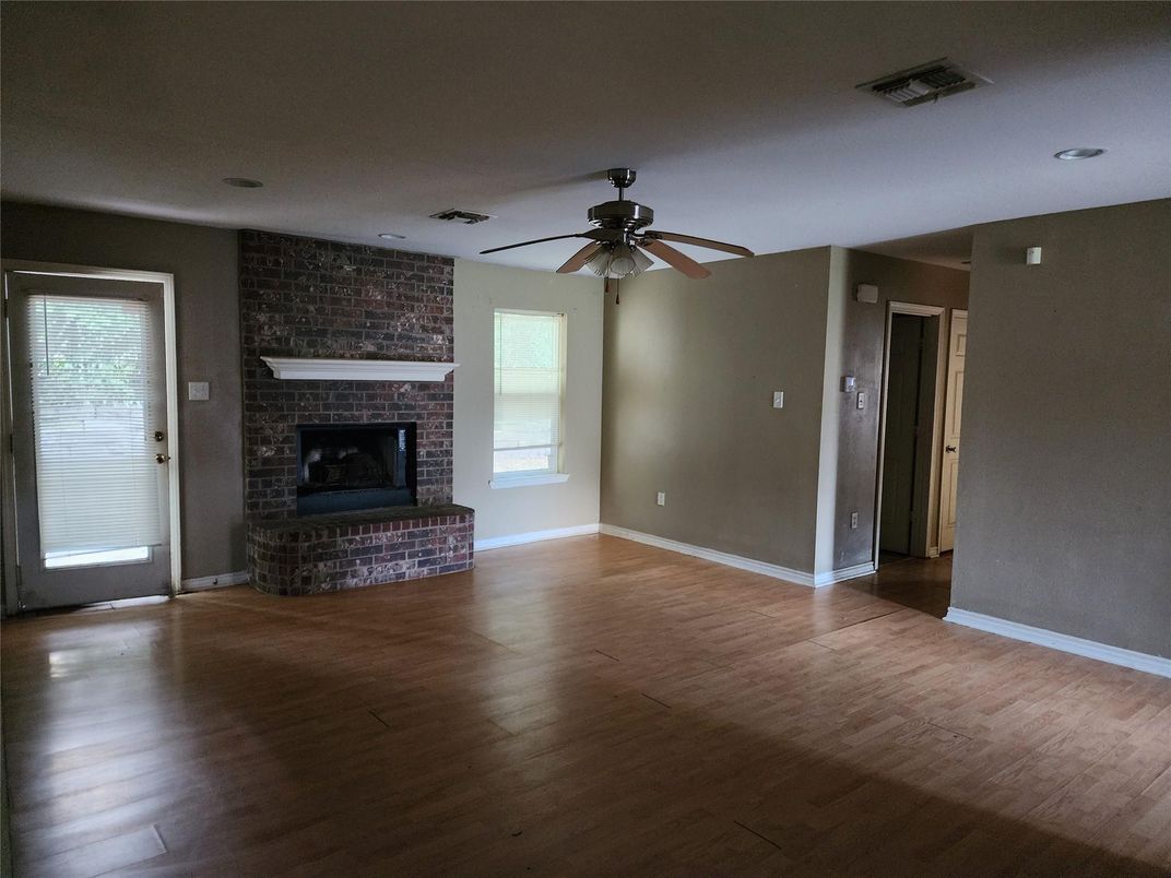 Empty room, Fireplace, Interior, Recessed Lighting, Stone Walls, Wood Texture Flooring