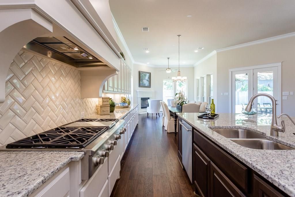 Dining room, Fireplace, Interior, Kitchen, Pendant Lights, Recessed Lighting, Stainless Steel Appliances, Wood Texture Flooring