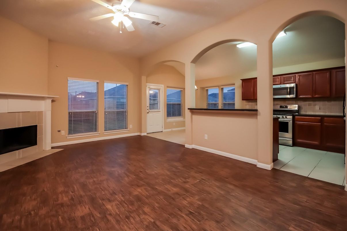 Empty room, Fireplace, Interior, Kitchen, Stainless Steel Appliances, Wood Texture Flooring