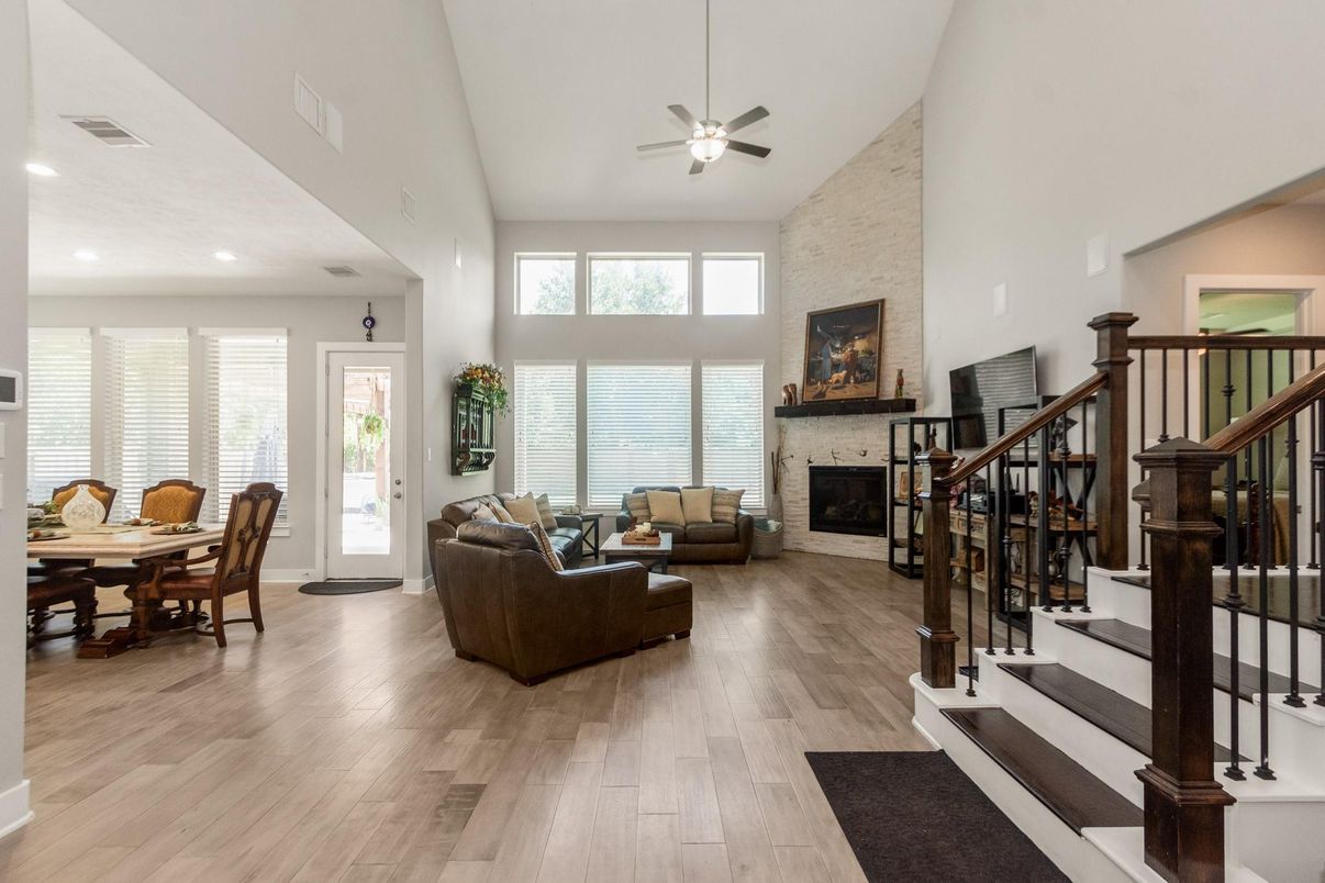 Dining room, Fireplace, Interior, Living room, Recessed Lighting, Stone Walls, Wood Texture Flooring