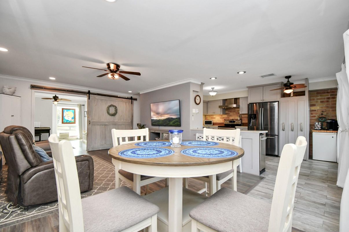 Dining room, Interior, Kitchen, Recessed Lighting, Stainless Steel Appliances, Stone Walls, Wood Texture Flooring