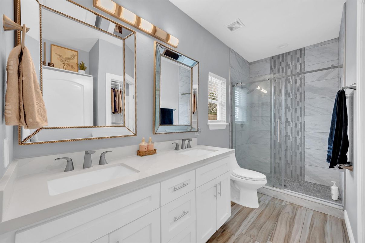 Bathroom, Dual Sink Vanities, Glass Shower, Interior, Marble Walls, Wood Texture Flooring