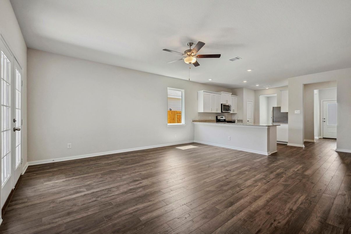 Empty room, Interior, Kitchen, Recessed Lighting, Stainless Steel Appliances, Wood Texture Flooring