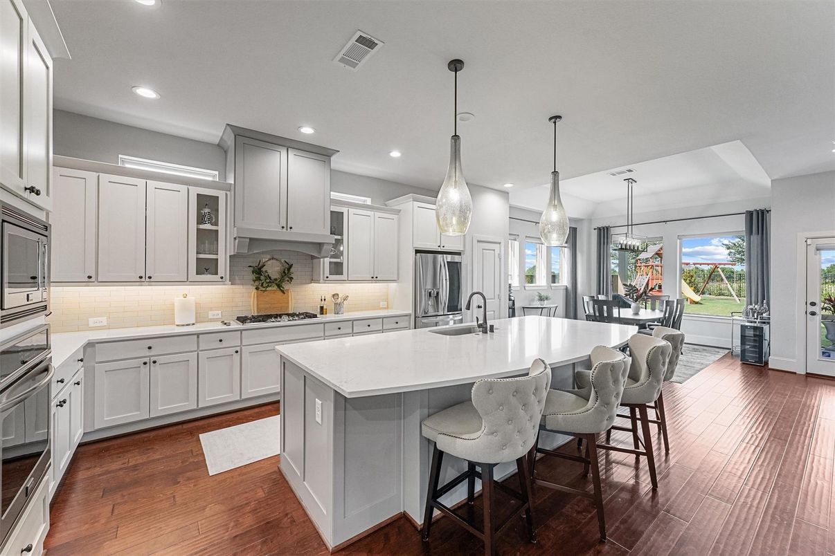 Dining room, Interior, Kitchen, Pendant Lights, Recessed Lighting, Stainless Steel Appliances, Wood Texture Flooring